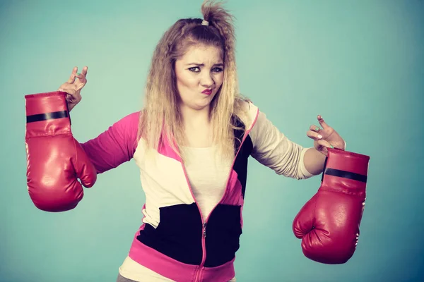 Disgusted woman holding boxing glove — Stock Photo, Image