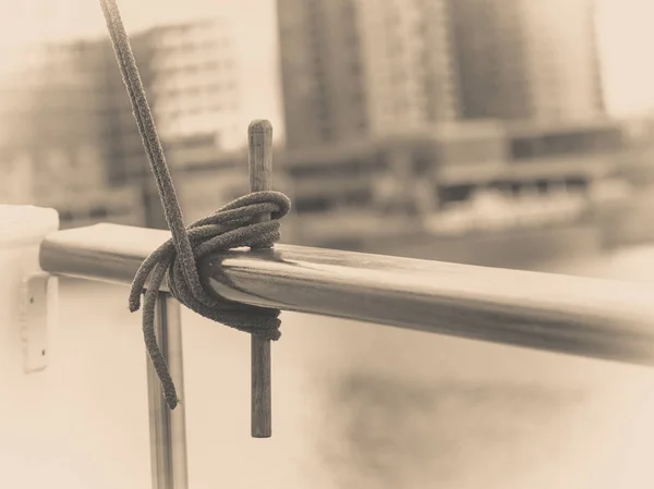 Rope tied around hook on handrail — Stock Photo, Image