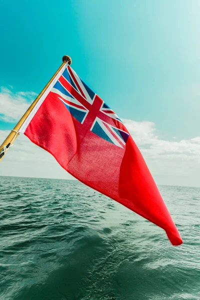 Uk red ensign the british maritime flag flown from yacht — Stock Photo, Image