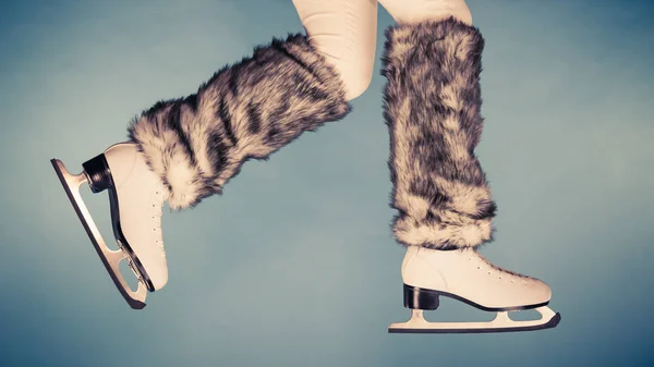 Woman legs wearing ice skates fur socks, skating — Stock Photo, Image