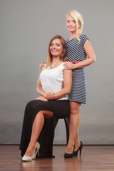 Two women wearing fashionable dresses. — Stock Photo, Image