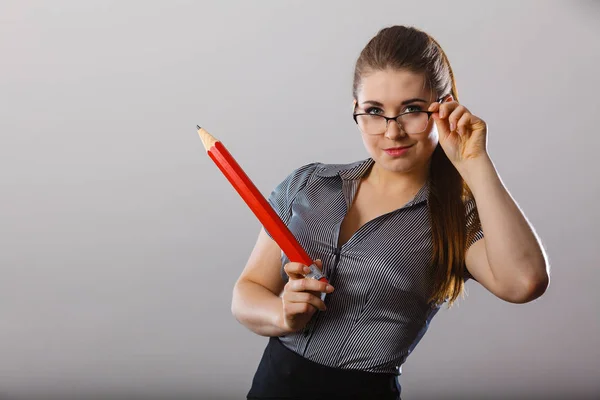 Lärare ser elegant kvinna som håller stora penna — Stockfoto