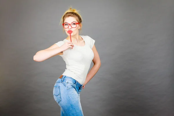 Happy woman holding fake lips on stick — Stock Photo, Image