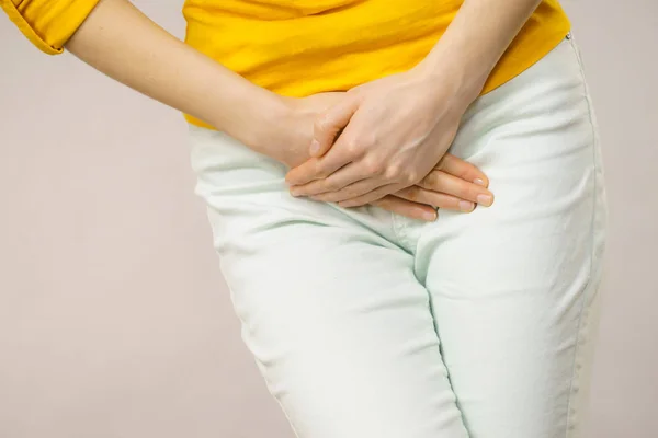 Woman with hands holding her crotch — Stock Image Woman with hands holding her crotch Royalty Free Stock Photos