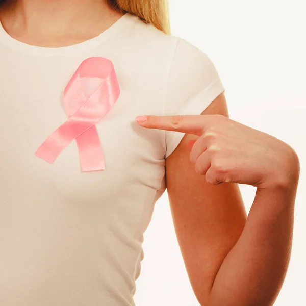Closeup pink cancer ribbon on woman chest — Stock Photo, Image