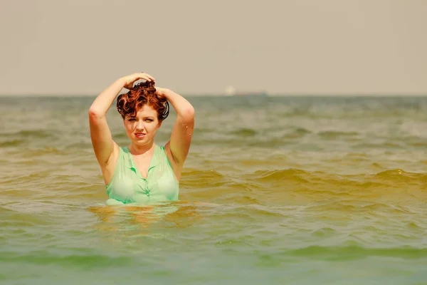 Redhead woman playing in water during summertime — Stock Photo, Image