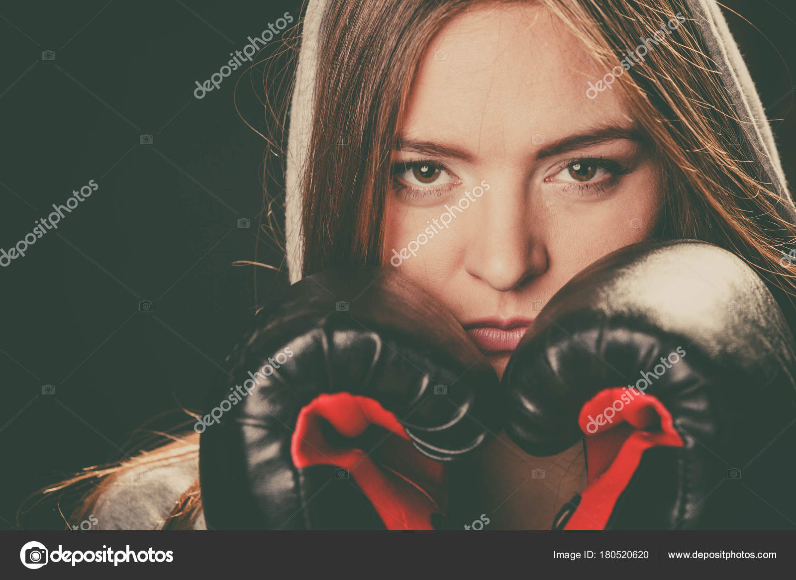 Woman cover face with boxing gloves. Stock Photo by ©Voyagerix 180520620