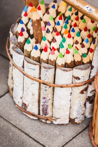Many colorful crayons in wooden bucket — Stock Photo, Image