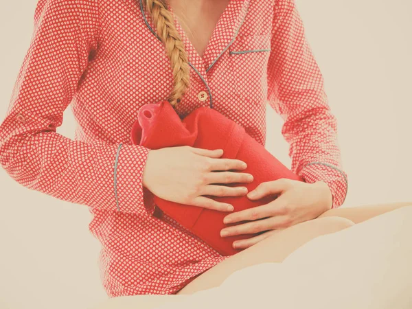 Woman feeling stomach cramps lying on bed — Stock Photo, Image