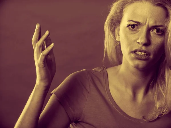 Angry, shocked blonde woman gesturing hands — Stock Photo, Image