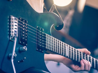 Close up of man playing on electric guitar clipart