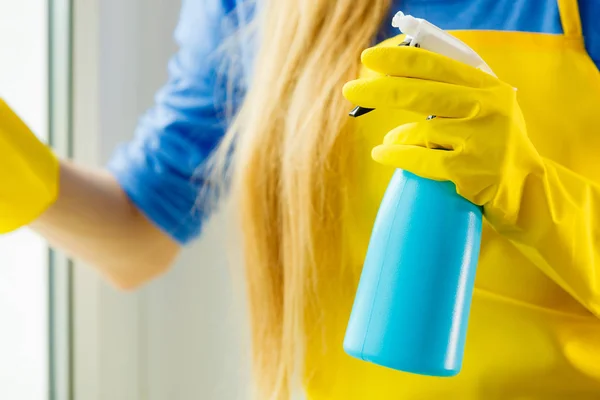 Hand cleaning window at home using detergent rag