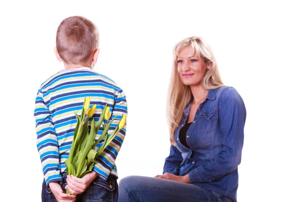 Little boy with mother hold flowers behind back. — Stock Photo, Image