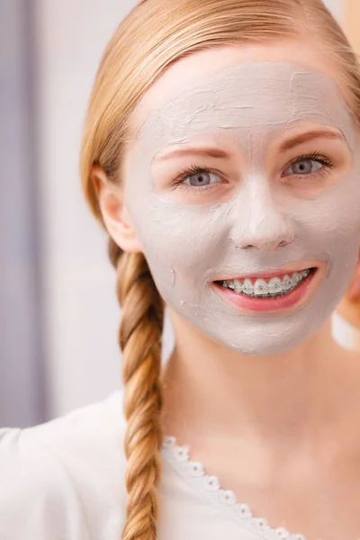 Woman with clay mud mask on her face — Stock Photo, Image