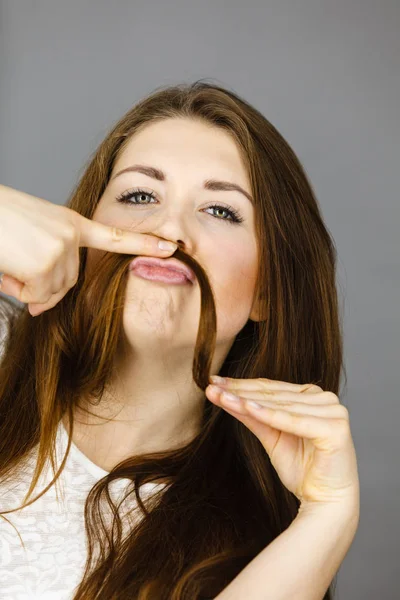 Woman having fun with her hair making moustache — Stock Photo, Image