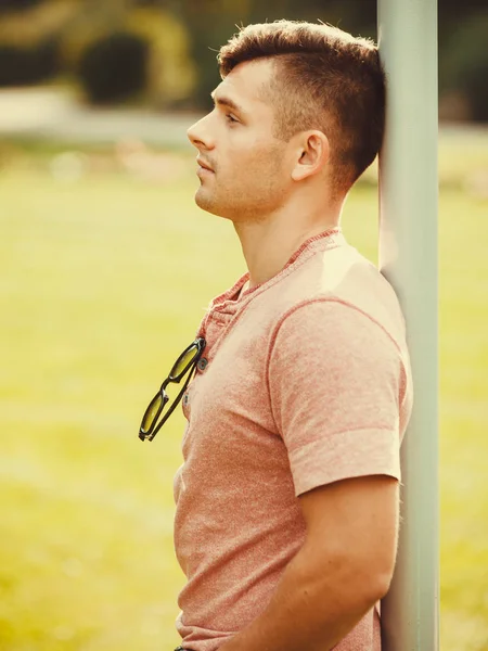 Relaxed boy leaning on pole. — Stock Photo, Image