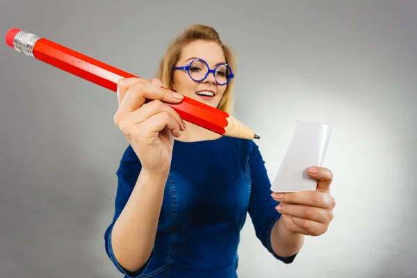 Mulher detém papel grande lápis nota na mão — Fotografia de Stock
