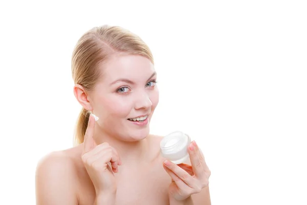 Woman applying face cream with her finger — Stock Photo, Image