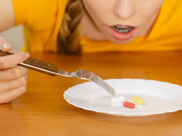 Потрясенная женщина с таблетками на тарелке — стоковое фото