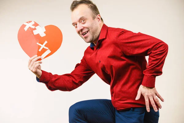 Adult man holding broken heart running — Stock Photo, Image