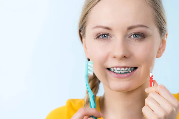 Vrouw glimlachend schoonmaken tanden met beugel — Stockfoto