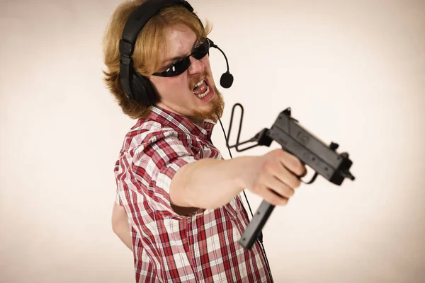 Gamer man shooting from gun — Stock Photo, Image