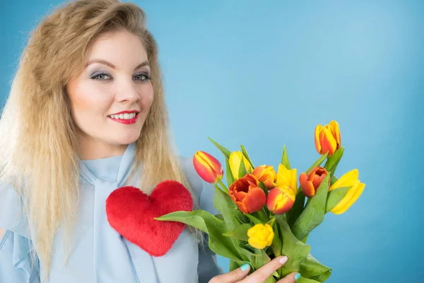 Kvinna håller tulpaner och rött hjärta — Stockfoto