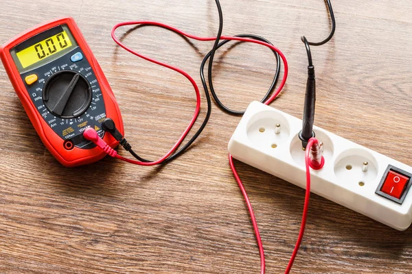 Measurement voltage in electrical socket with multimeter — Stock Photo, Image