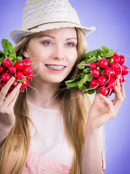 Young woman holding radish — Stock Photo, Image