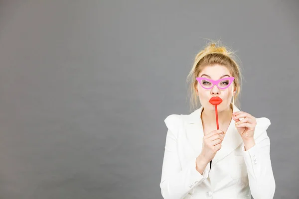 Happy elegant woman holding carnival accessoies on stick — Stock Photo, Image