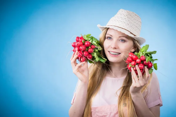 Young woman holding radish — Stock Photo, Image