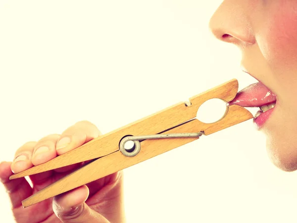 Blonde woman having tongue in clothespin — Stock Photo, Image