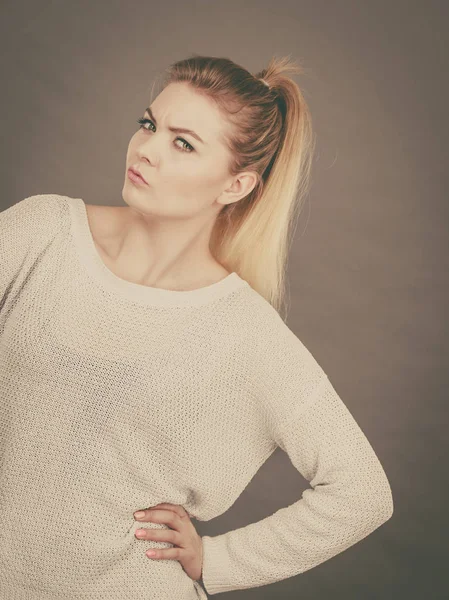Verwirrte junge blonde Frau sieht verdächtig aus — Stockfoto