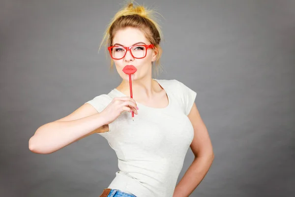 Happy woman holding fake lips on stick — Stock Photo, Image