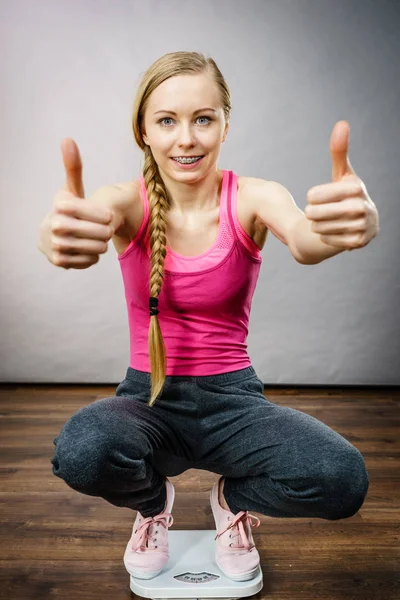 Teenage woman on bathroom scale machine — Stock Photo, Image