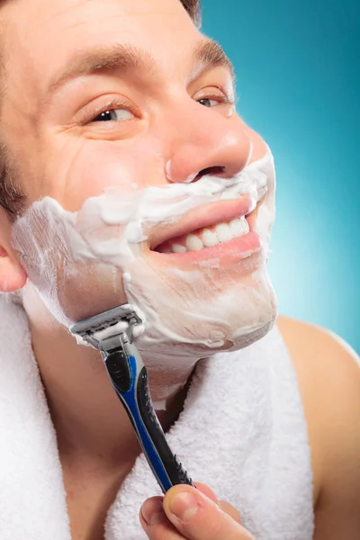 Happy man shaving using razor with cream foam. — Stock Photo, Image