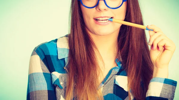 Happy nerdy woman in glasses holding pen — Stock Photo, Image