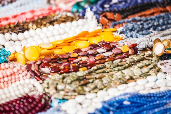 Many decorative necklaces made of colorful stones — Stock Photo, Image