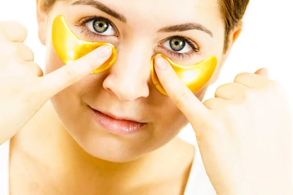 Woman with gold patches under eyes — Stock Photo, Image