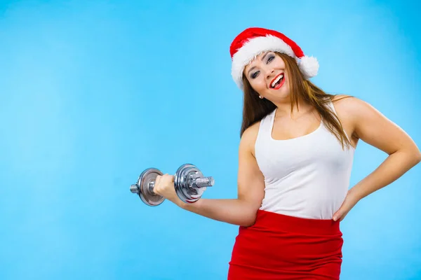 Święty Mikołaj kobieta podnoszenia hantlami — Zdjęcie stockowe