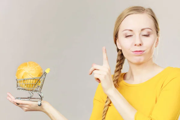 Vrouw met winkelwagentje met brood — Stockfoto