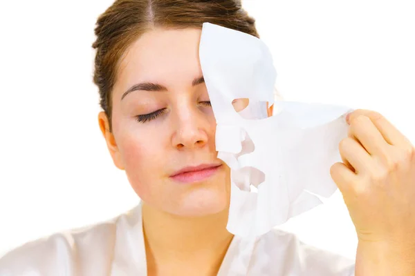 Woman remove sheet mask from face — ストック写真
