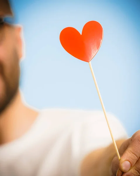 Man with heart on stick — Stock Photo, Image