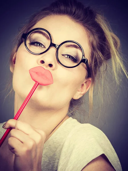 Happy woman holding fake lips on stick — Stock Photo, Image