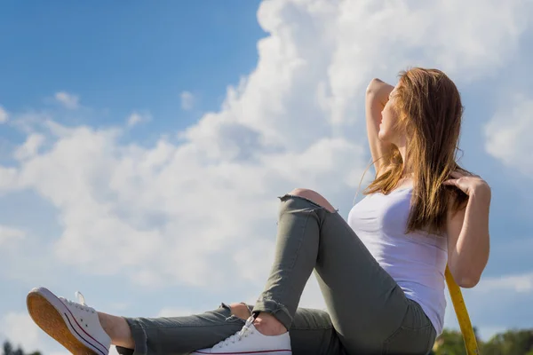 Girl wearing trousers and sneakers relax outdoor — Stock Photo, Image