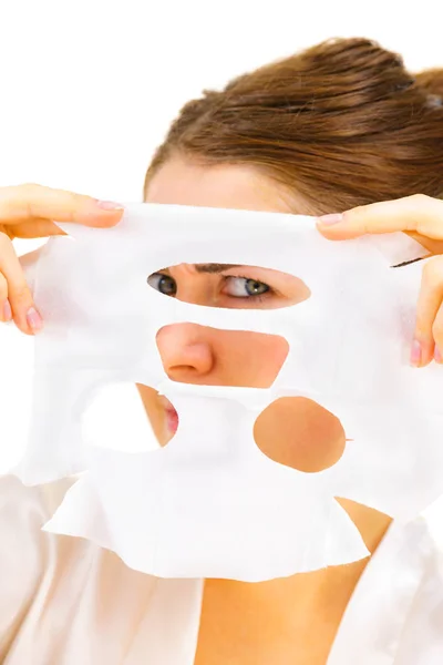 Woman applying sheet mask on face — Stock Photo, Image