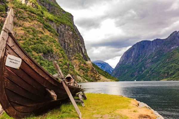 Old viking boat on fjord shore, Norway