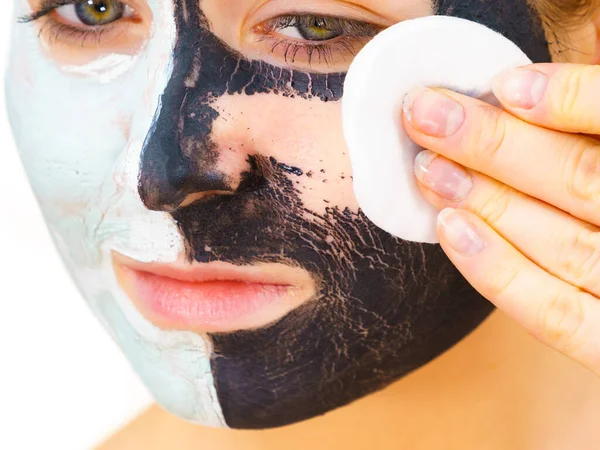Girl remove black white mud mask from face — Stock Photo, Image