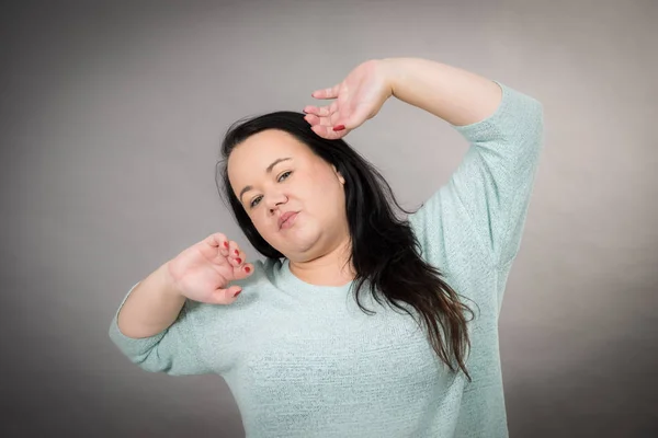 Adult tired woman stretching her arms up — Stock Photo, Image