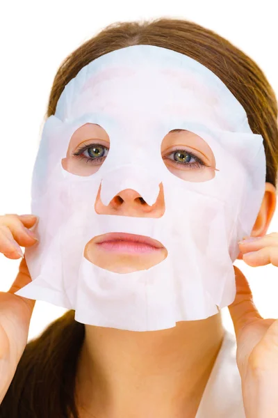 Woman applying sheet mask on face — Stock Photo, Image